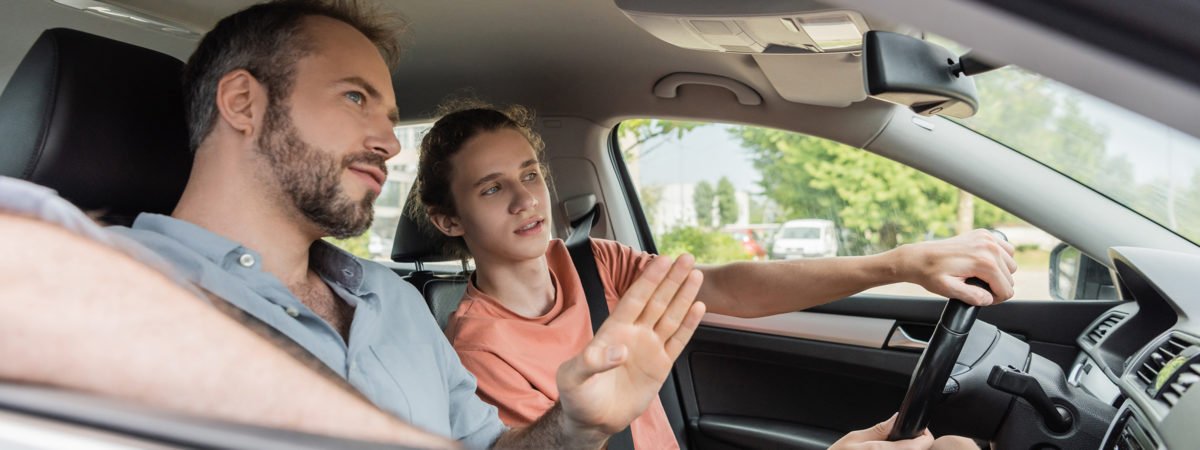 Teen driver learning from father